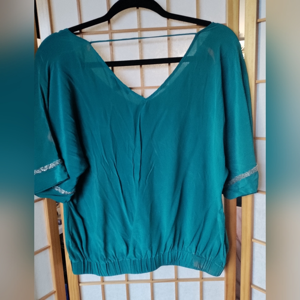 100% Silk Blouse in a soft teal color with beaded trim on sleeves. Size Medium